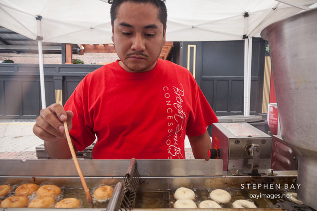 Cooking donuts at the farmers market. Des Moines, Iowa.