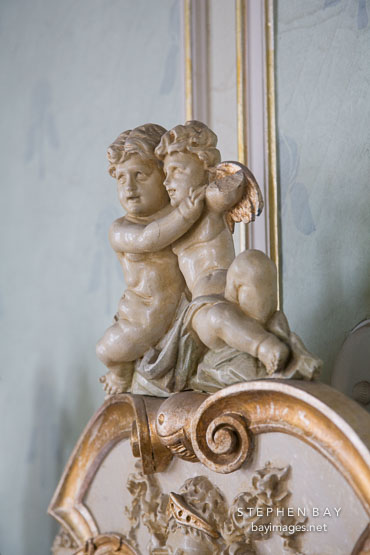 Two cupids on headboard. WIndsor Room. Casa Loma, Toronto.