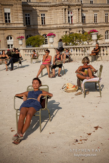 Parisians sunning themeselves at the Luxembourg gardens. Paris, France.