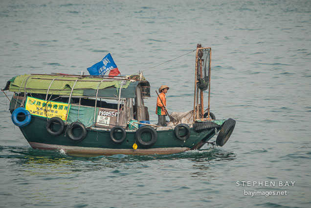 Fishing boat in Victoria Harbor. Hong Kong, China.