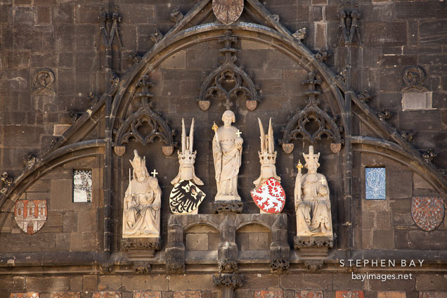 Statues on the Charles bridge tower. Prague, Czech Republic.