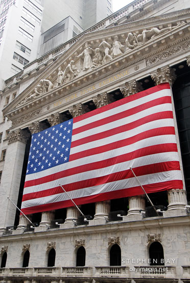 American flag and New York Stock Exchange. New York City, New York, USA.
