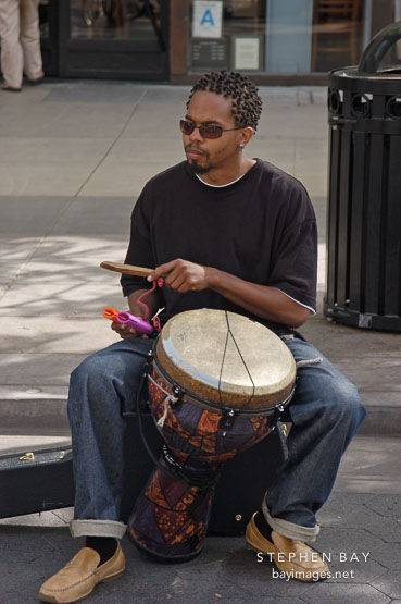 Musician playing a drum. Third street promenade, Santa Monica, California, USA.