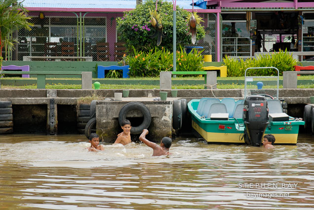 Children playing in the water. Toruguero village, Costa Rica.
