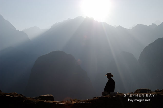 Sunbeams and tourist at Machu Picchu, Peru.