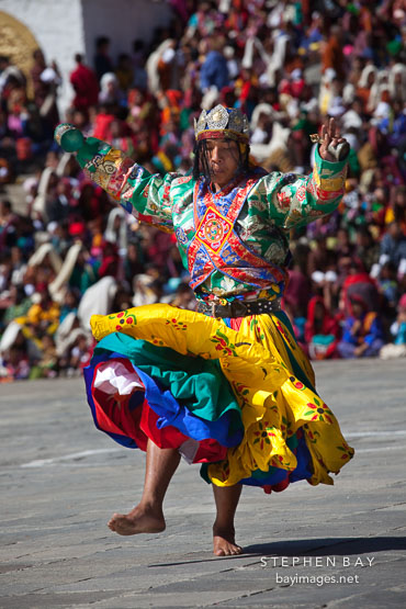 Dancer holding small bell and small drum. Thimphu tsechu, Bhutan.