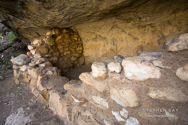 Wall created from limestone rocks and gold-colored clay. Walnut Canyon National Monument, Arizona.