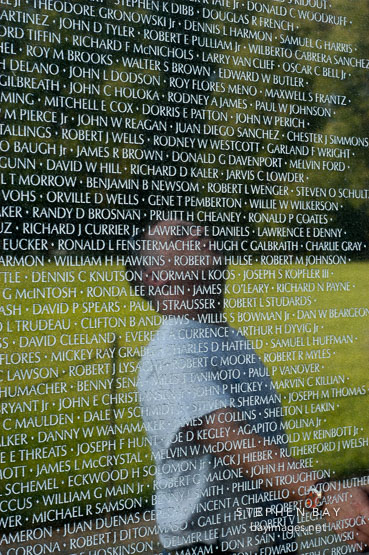 Reflection of a man on the Vietnam Veteran's Memorial Wall. Washington, D.C.