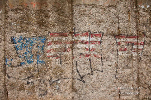 Worn graffiti on the Berlin Wall. Berlin, Germany.