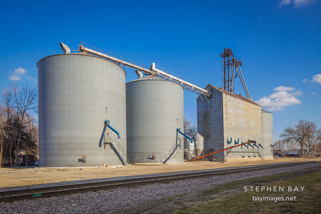 Grain elevator by train tracks. Gilbert, Iowa.