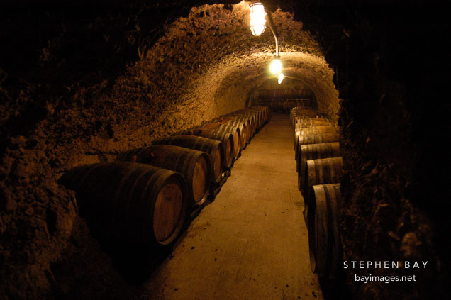 Wine barrels in underground storage. Napa Valley, California, USA.