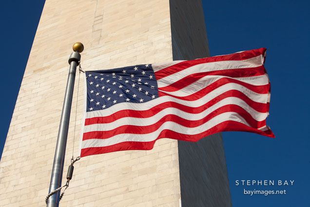 American flag blowing in the wind at the Washington Monument.