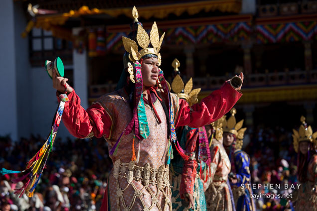 Dancer wearing ornate dress and bone carvings. Thimphu tsechu, Bhutan.