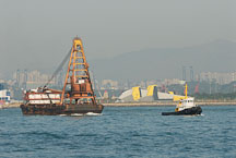 Tugboat pulling barge. Victoria Harbor, Hong Kong, China. - Photo #15623
