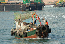 Small fishing boat in Victoria Harbor. Hong Kong, China. - Photo #15627