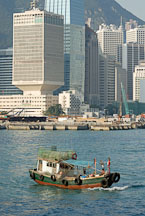Fishing boat with skyscrapers in the background. Hong Kong, China. - Photo #15633