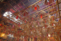The ceiling of the Man Mo Temple is covered with hanging incense coils. Hong Kong, China. - Photo #15139