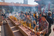 Large crowds of people light incense for their ancestors at the Wong Tai Sin Temple. Hong Kong, China. - Photo #15740