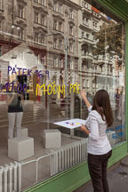 Young woman uses finger paint to advertise an art exhibit for fashion week at Manes Exhibition Hall. Prague, Czech Republic. - Photo #30044