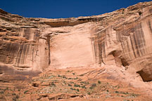 Canyon del Muerto wall with tiny ruin in bottom right. Canyon de Chelly NM, Arizona. - Photo #18145
